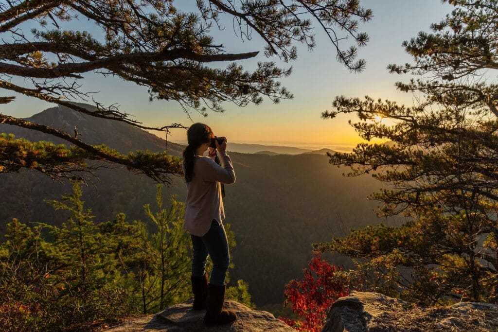 Wendy Frederick photographing the Blue Ridge Mountains at sunrise from Wiseman’s View in North Carolina